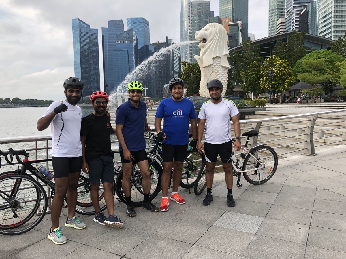 Posing with the bike at a park entrance