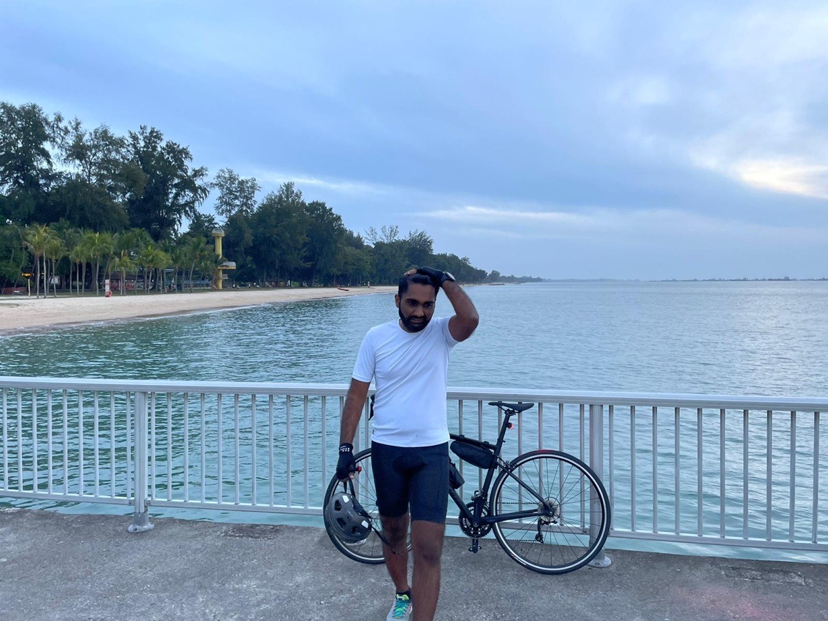 On the bike in a teal jersey